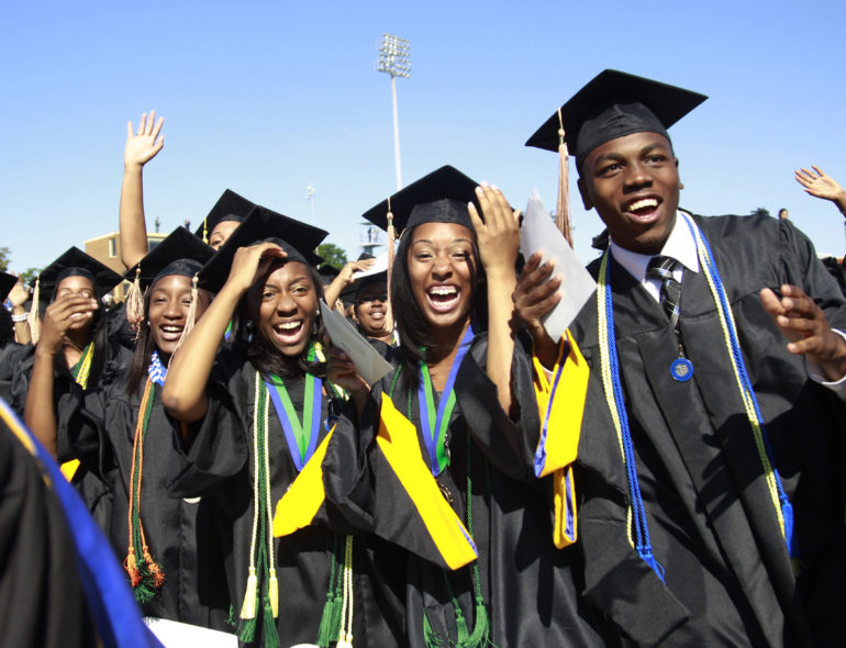 Students react during the graduation ceremony of the 2010 class at Hampton University in Virginia May 9, 2010. U.S. President Barack Obama delivered the commencement address at the graduation and was conferred an honorary doctor of laws degree.     REUTERS/Jason Reed   (UNITED STATES - Tags: POLITICS EDUCATION IMAGES OF THE DAY) - RTR2DNV8